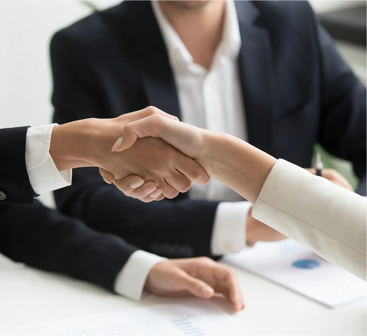People shaking hands over a business meeting