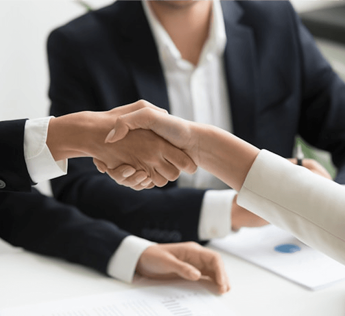People shaking hands over a business meeting